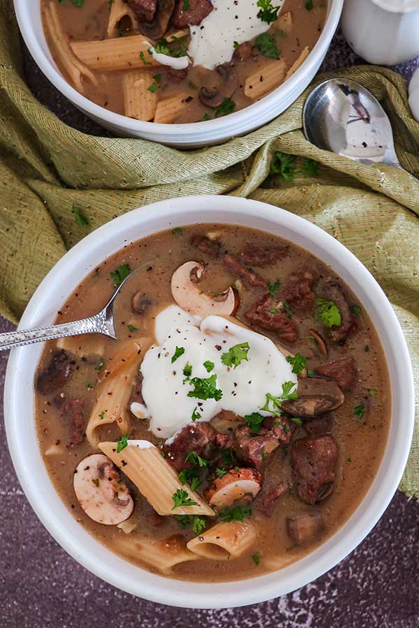 2 bowl of beef stroganoff soup topped with sour cream