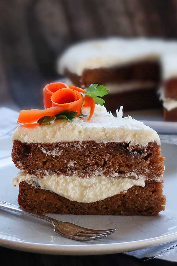 a slice of vegan carrot cake on a dessert plate