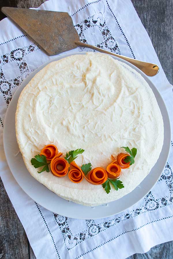 overview of vegan gluten free Easter cake with frosting and carrot roses