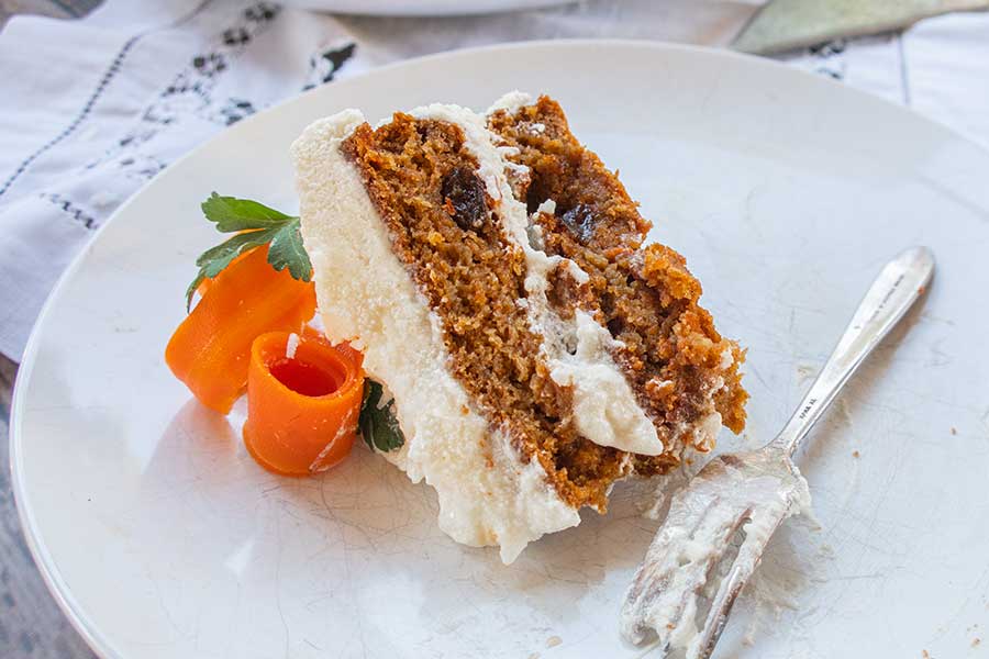 vegan carrot cake on a small plate with a fork