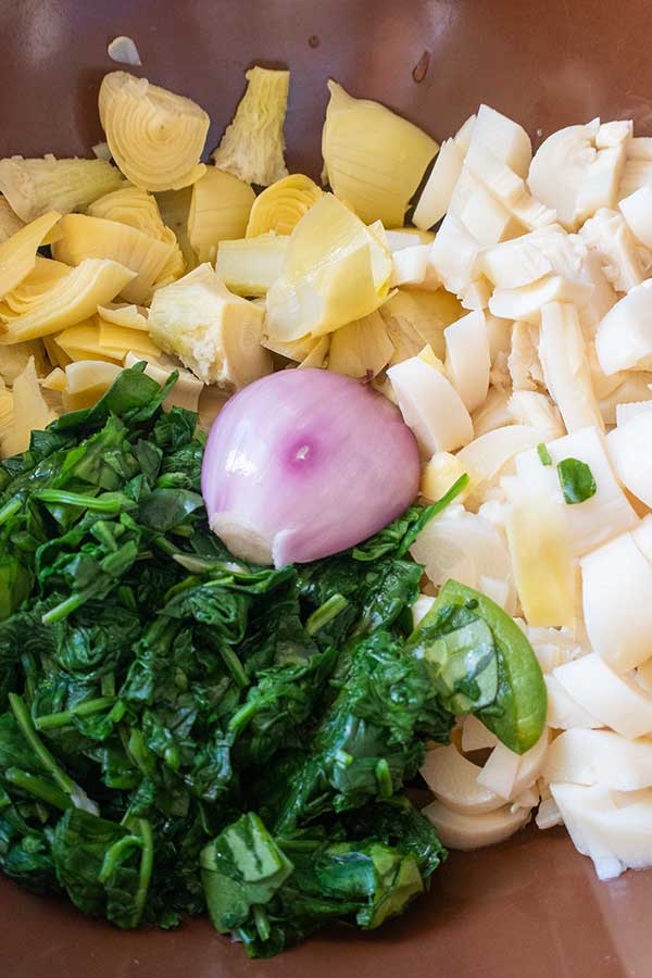 artichokes spinach and hearts of palm in a bowl