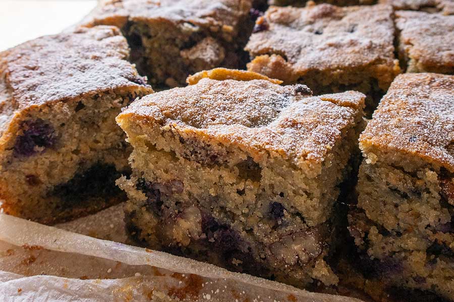 sliced blueberry pecan breakfast cake on a tray