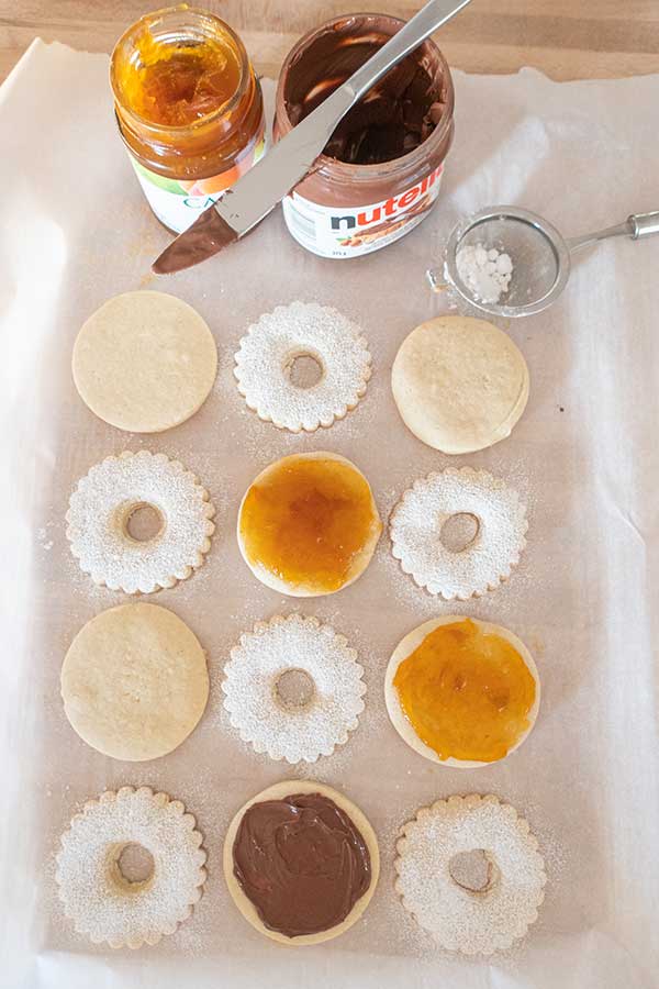 spreading filling on top of cookies