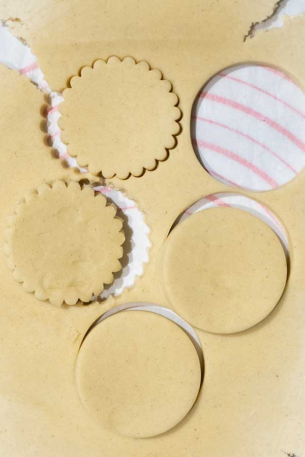 cookie dough cut outs on parchment paper