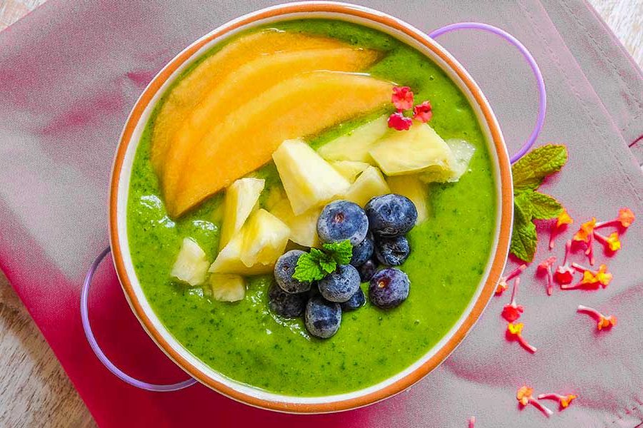 pineapple green smoothie bowl with toppings
