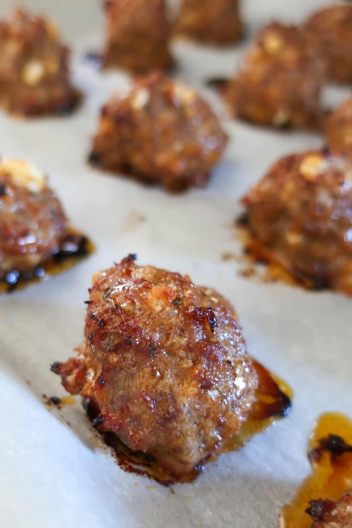 close up of a gluten free baked meatball on a baking sheet