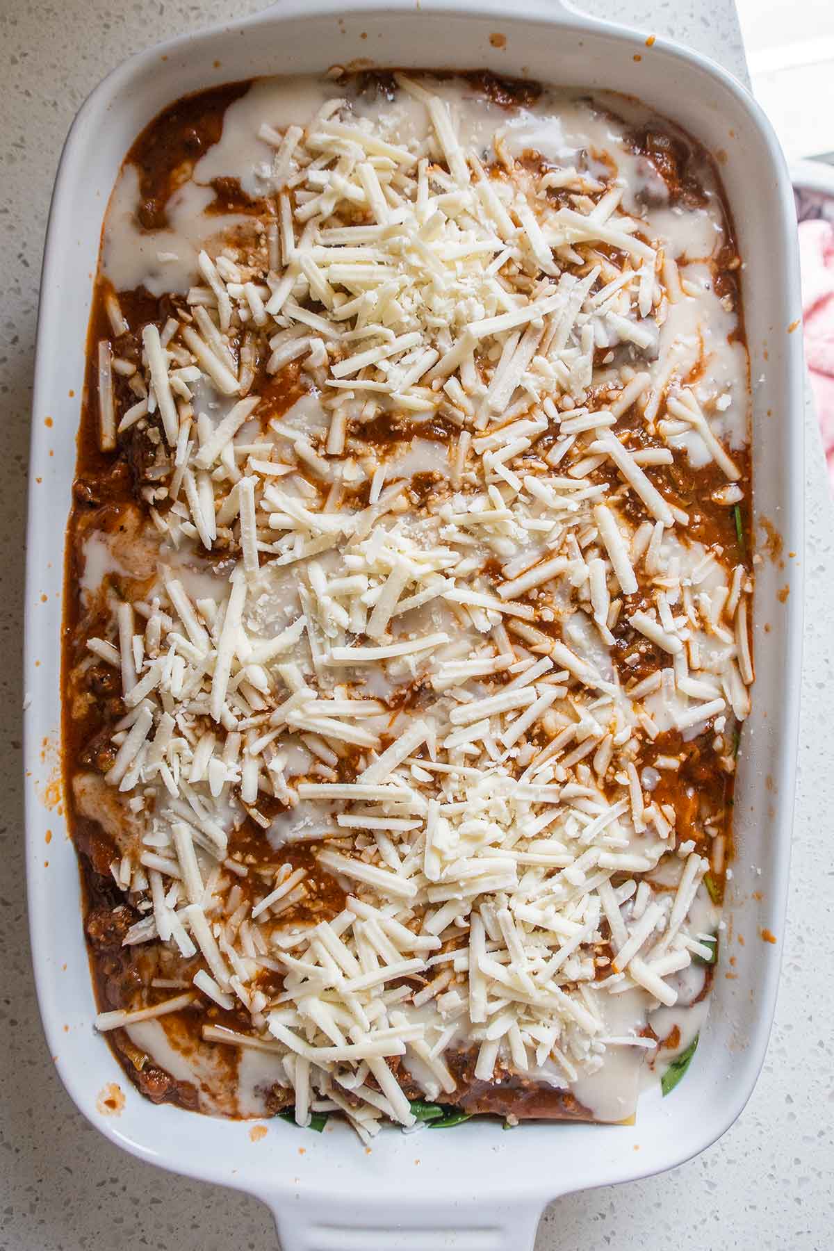 overview of unbaked lasagna in a baking dish