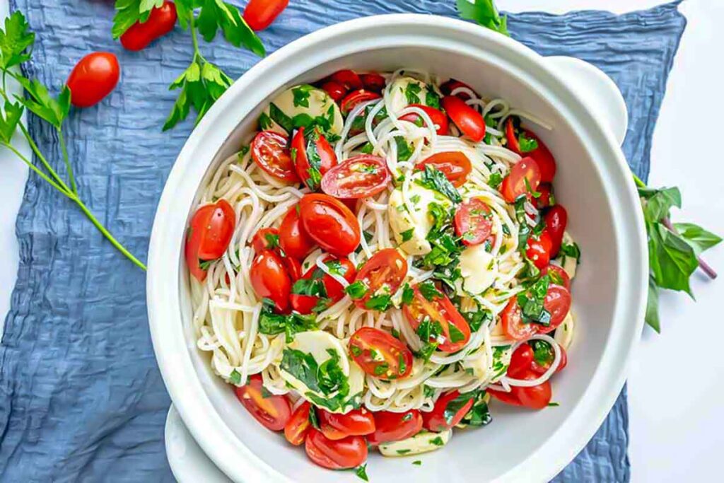 chilled spaghetti with cherry tomatoes and Italian vinaigrette in a bowl