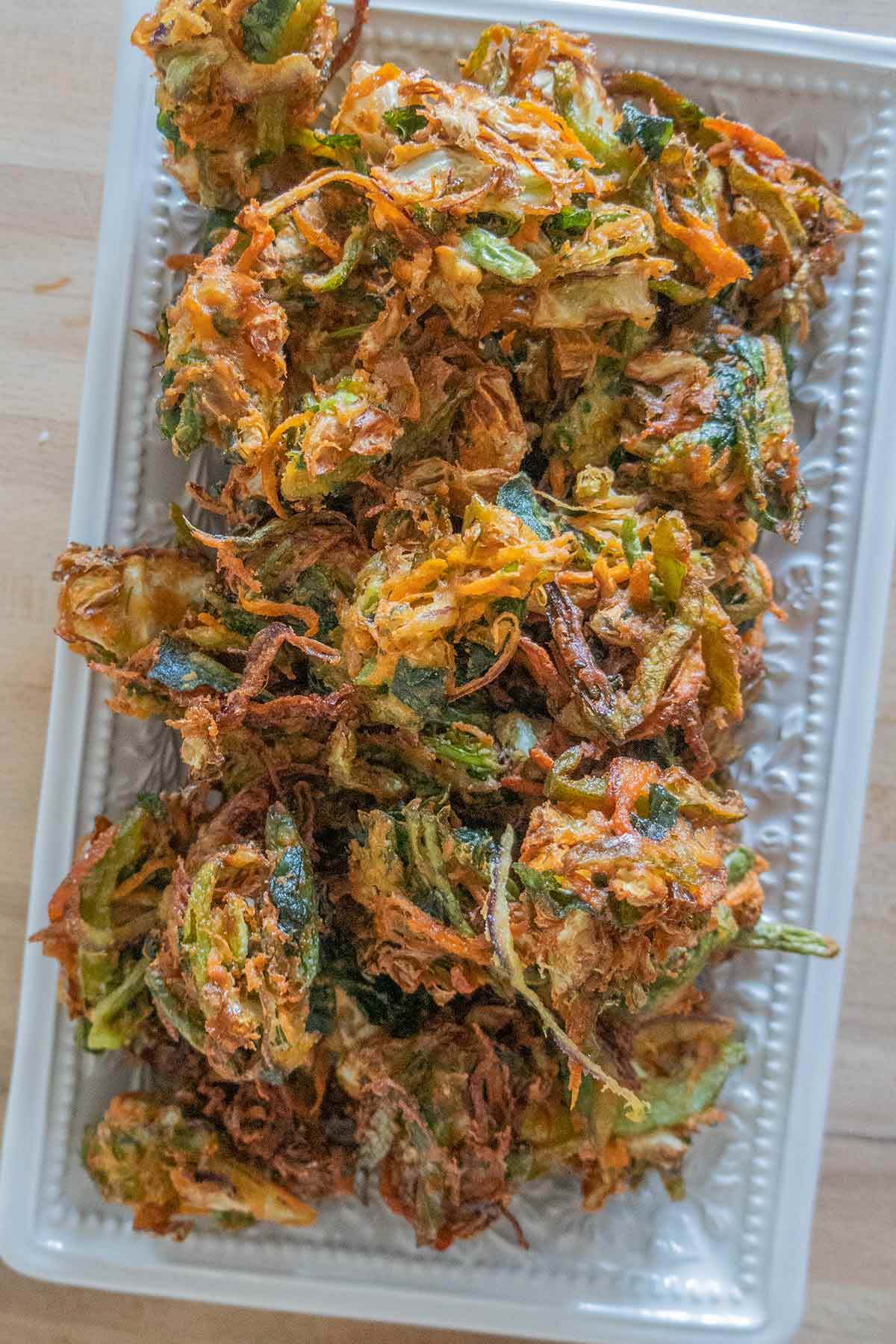 stacked vegetable pakoras on a platter