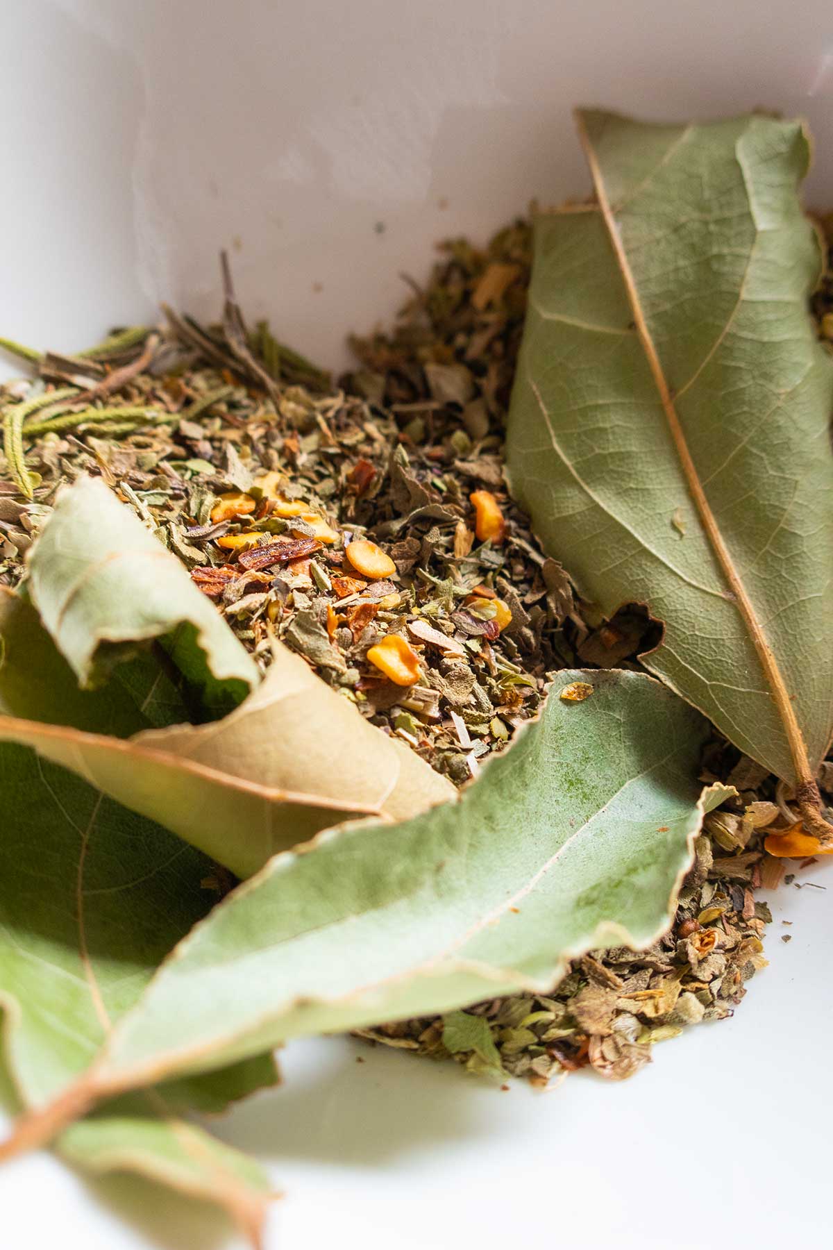 dried Italian spices in a white bowl