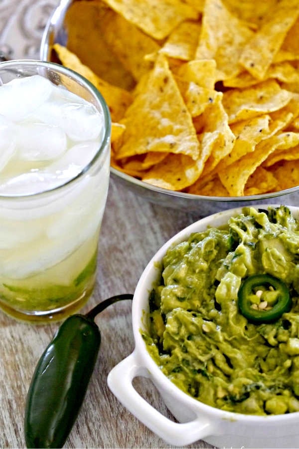 bowl of spicy creamy guacamole just like traditional Mexican recipe for game day