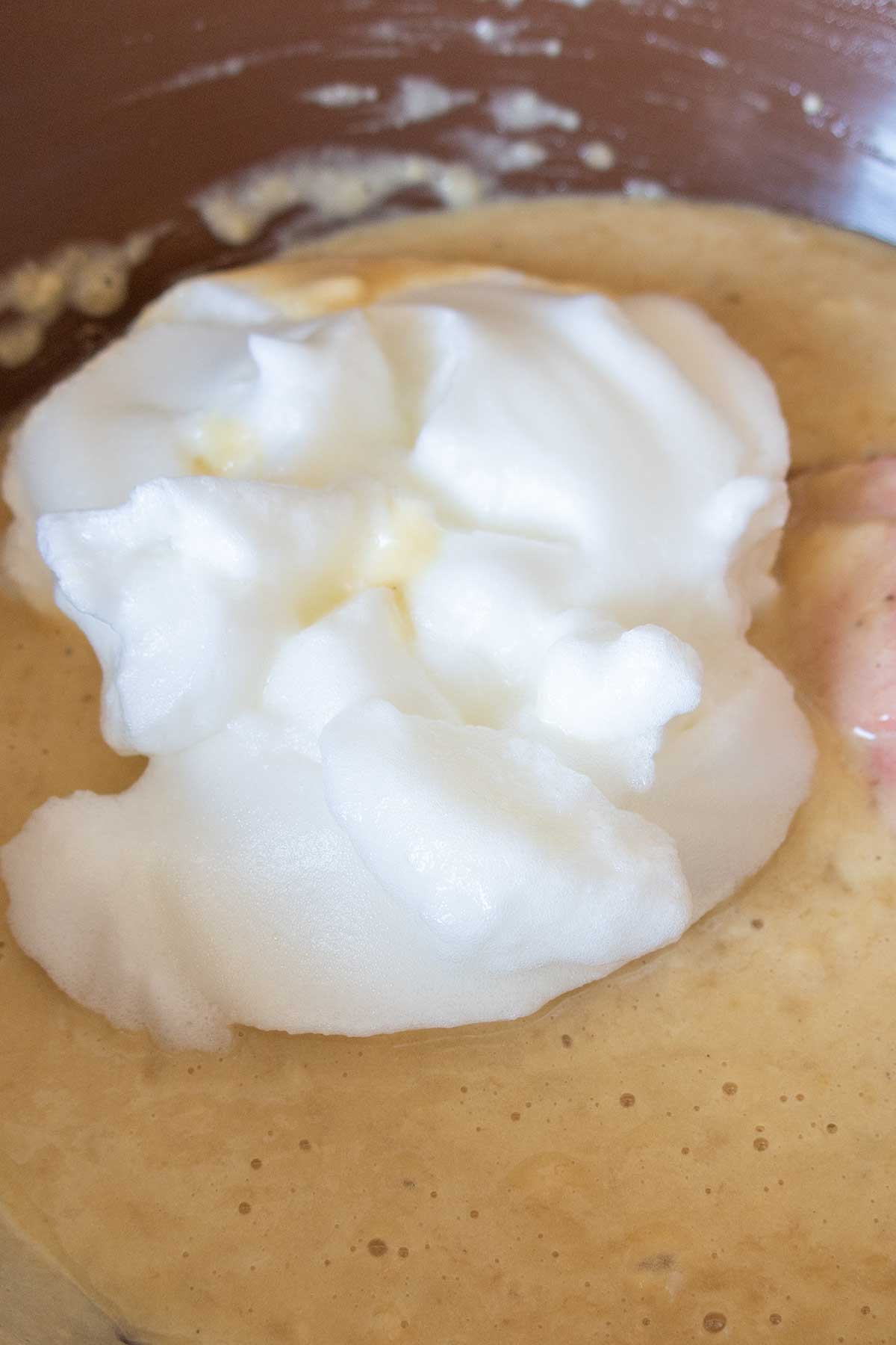 batter topped with whipped egg whites in a bowl