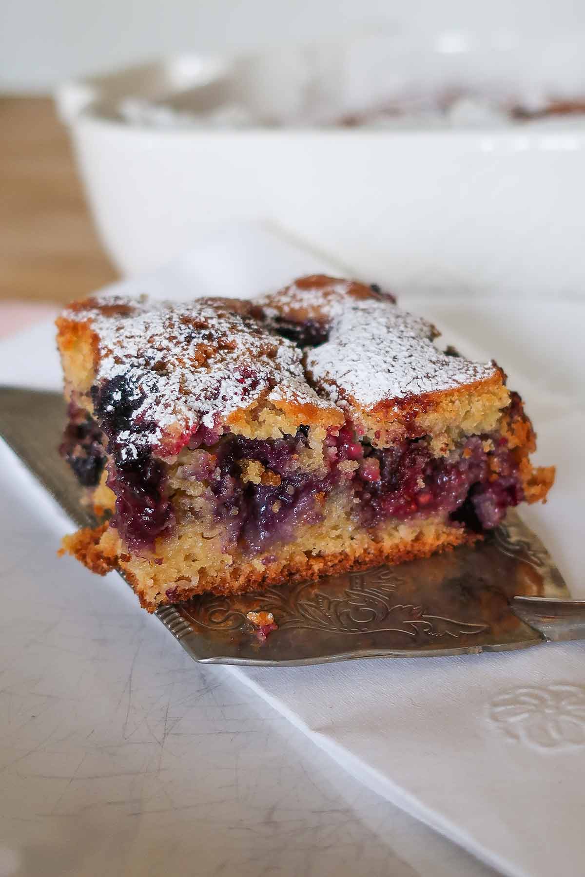 a slice of gluten free berry coffee cake on a plate