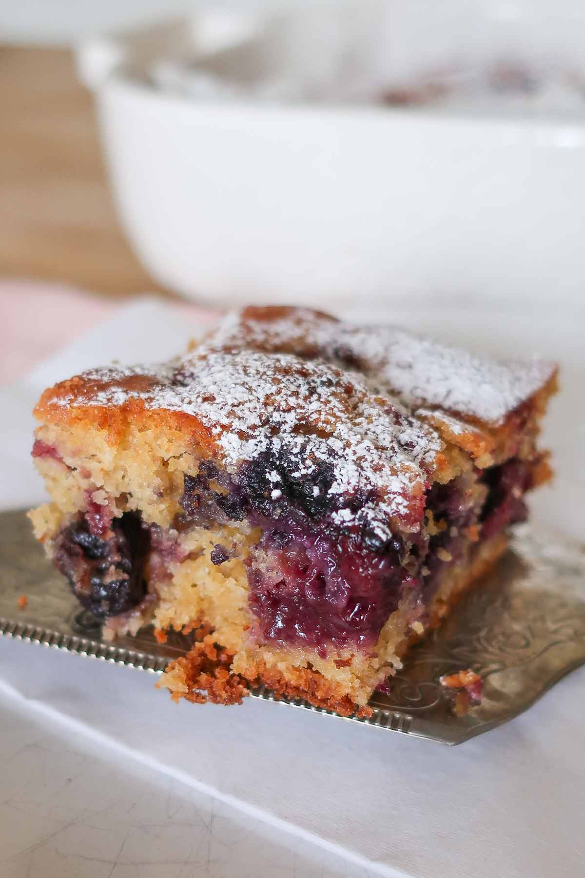 close up of a berry coffee cake slice on a spoon