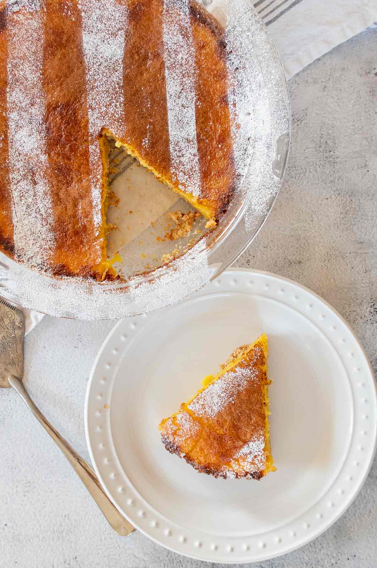 slice of chess pie on a plate next to whole chess pie in a pie dish