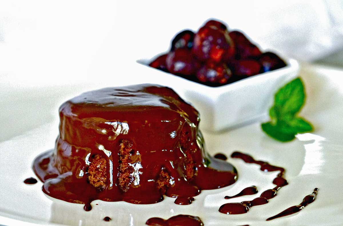 mini chocolate cake with ganache sauce on a plate