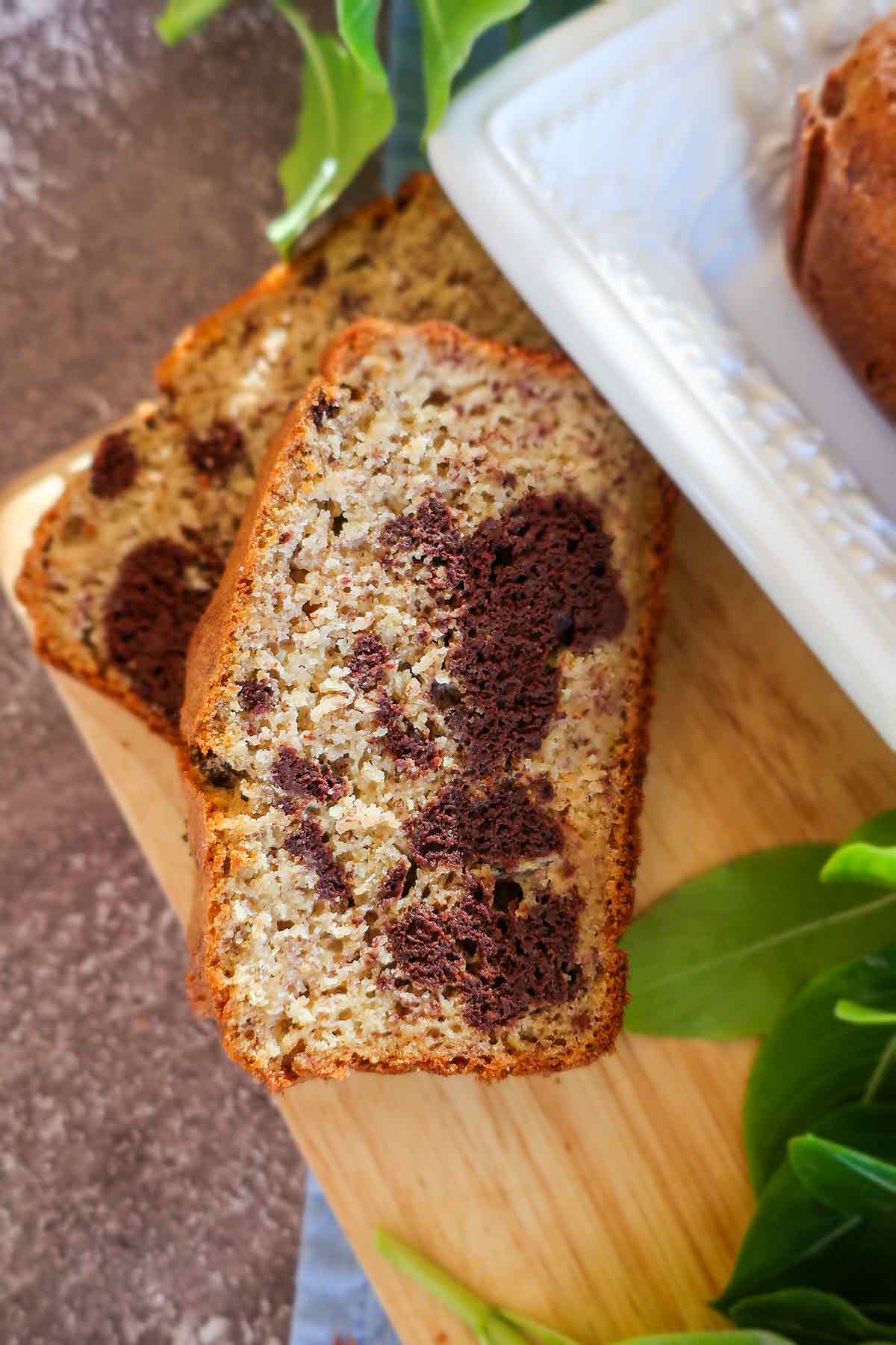 2 slices of marbled banana bread on a cutting board