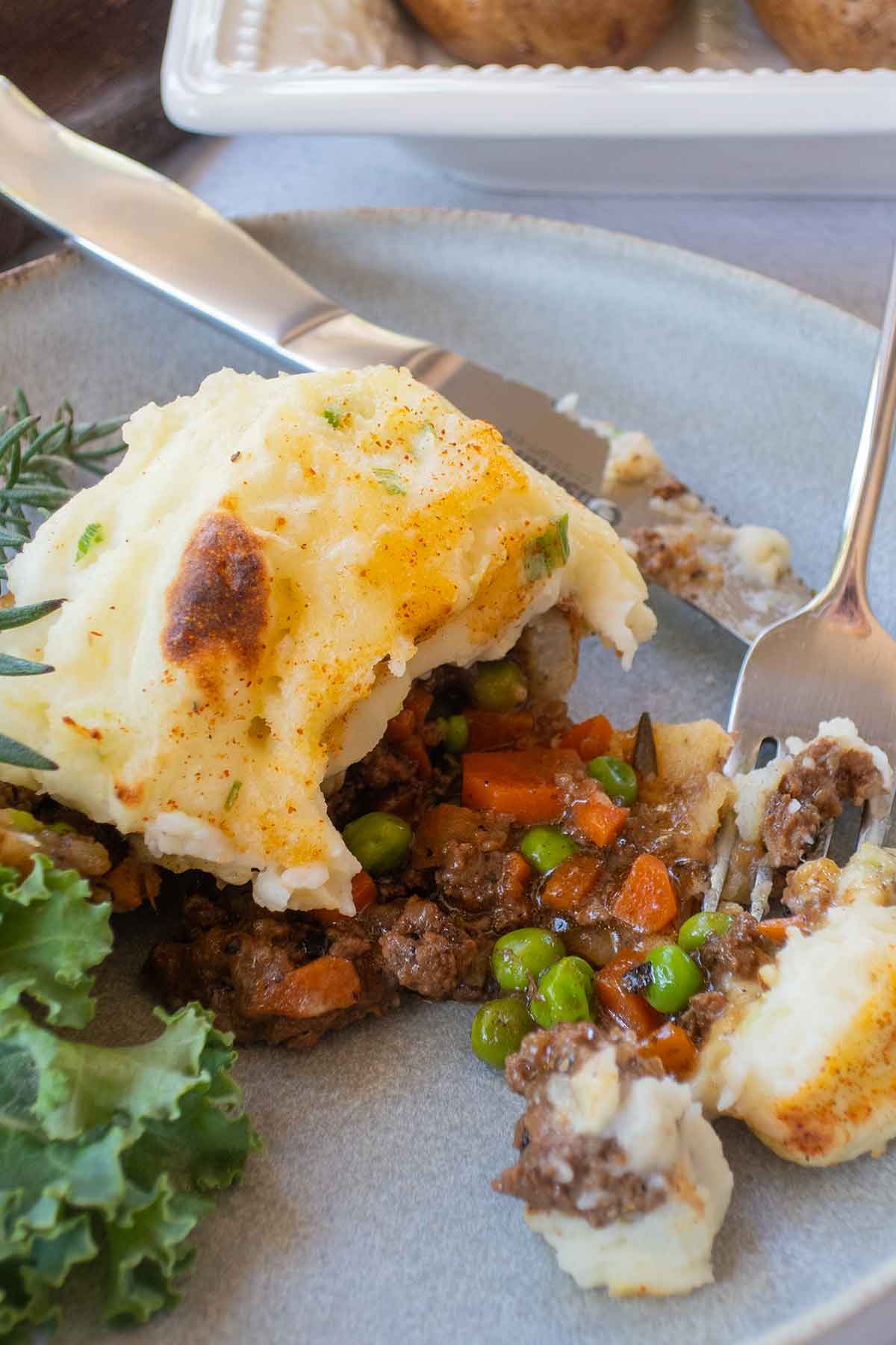 half a double baked potato with shepherd’s pie filling on a plate