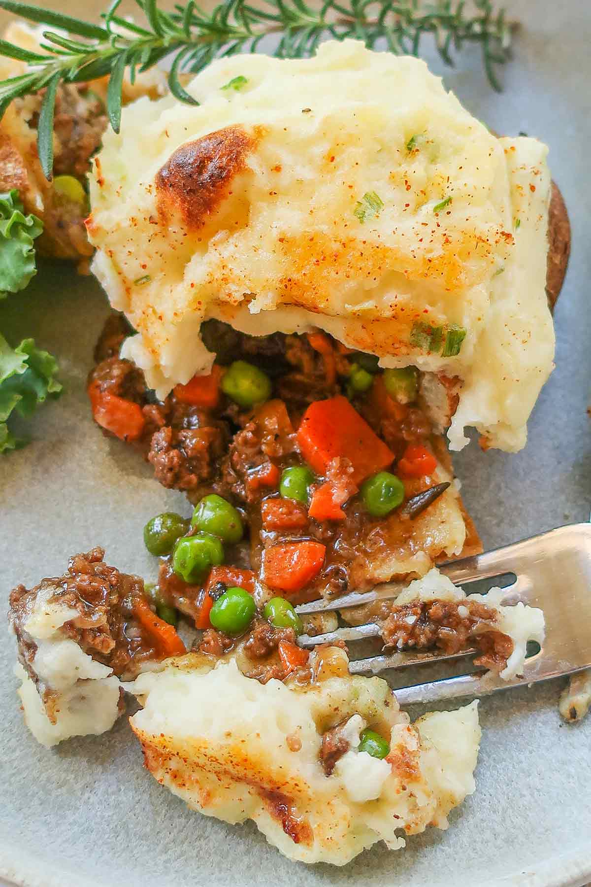 shepherd’s pie double baked potato halved with a fork