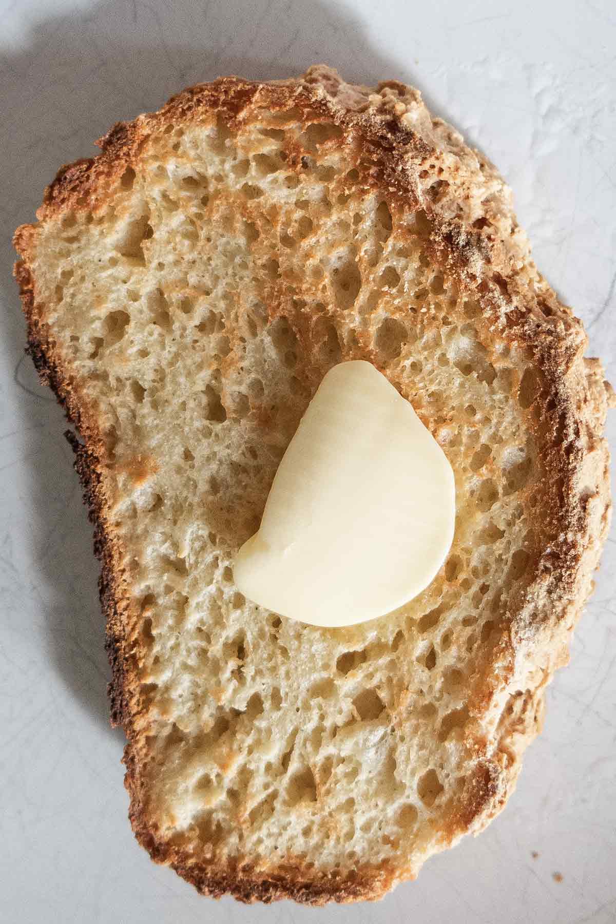 toasted slice of gluten free potato bread with a pat of butter