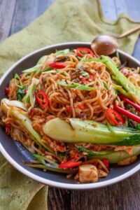 15 minute gluten free schezwan noodles with bok choy on a plate