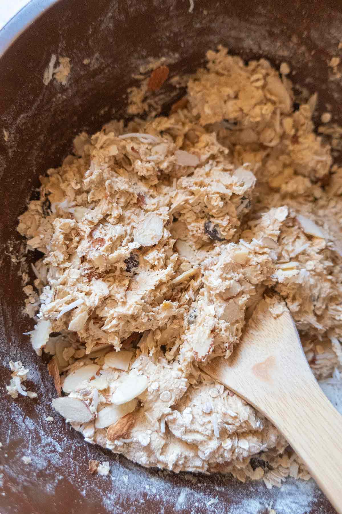 cookie dough in a bowl with wooden spoon