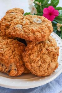 stacked gluten free cowboy cookies on a dessert plate