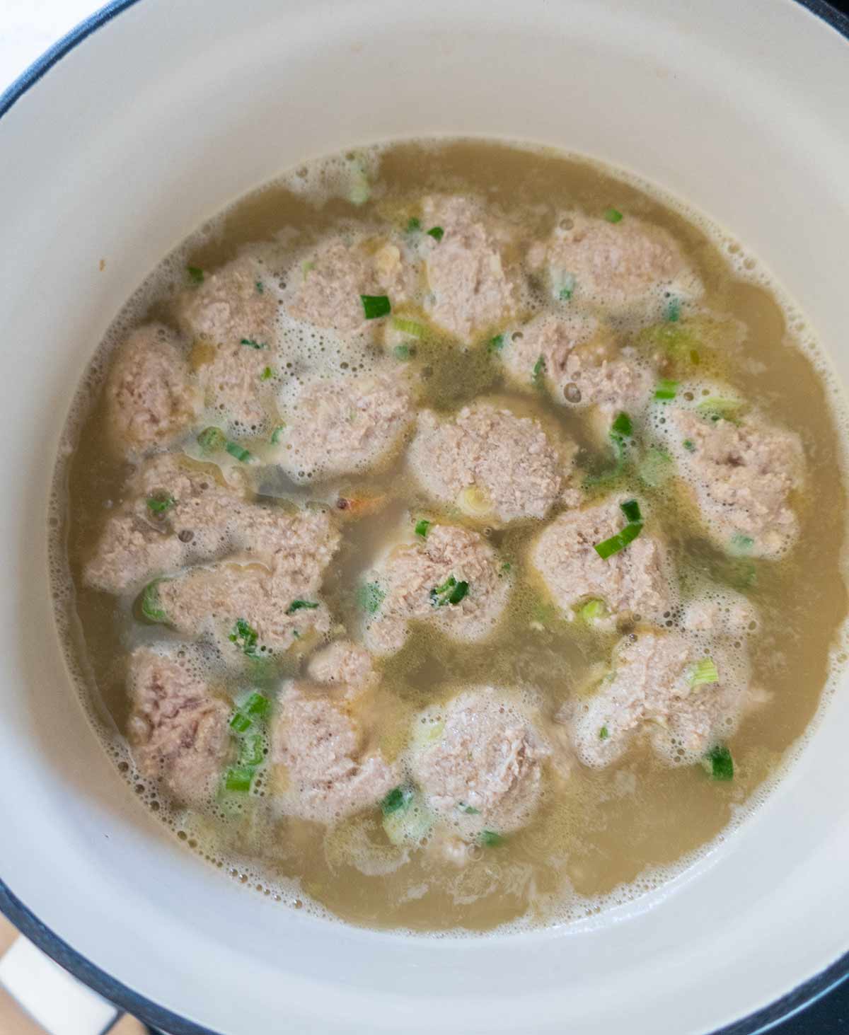 meatballs cooking in broth