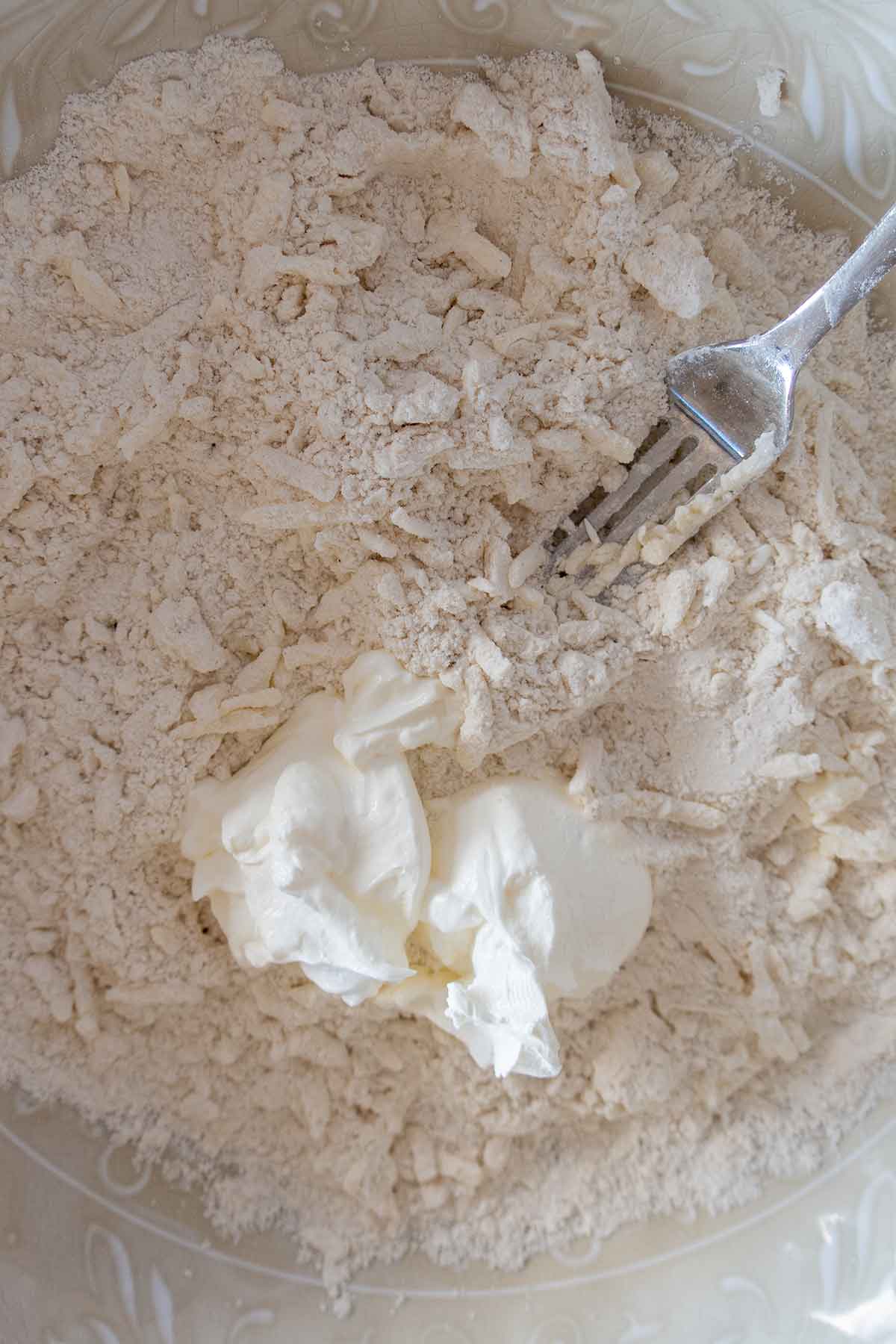 mixing sour cream into flour for gluten free pie crust
