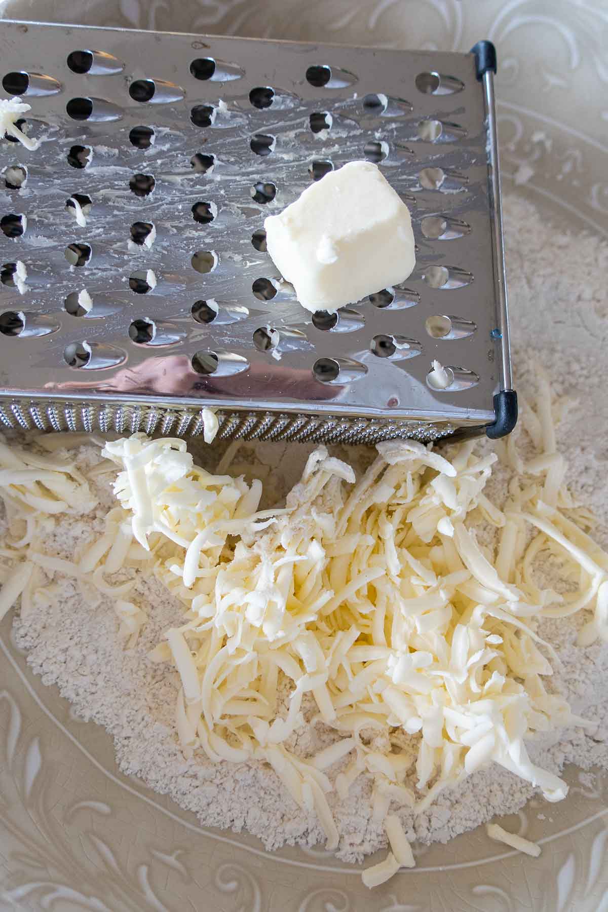 grated frozen butter in pie crust flour mixture