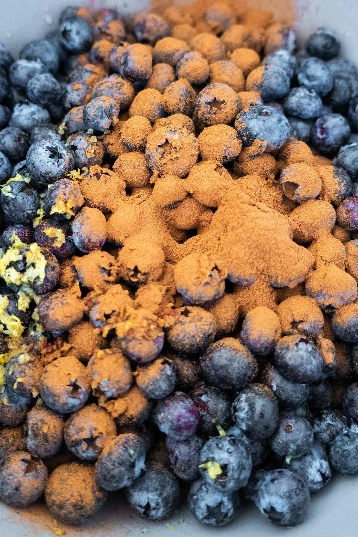 blueberries, cinnamon, lemon zest and juice in a bowl