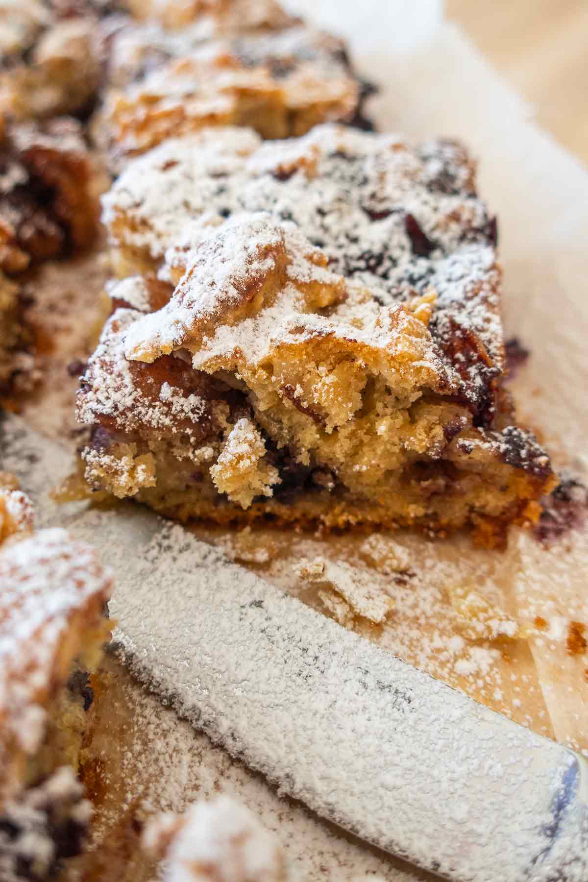 a slice of breakfast bar dusted with powdered sugar