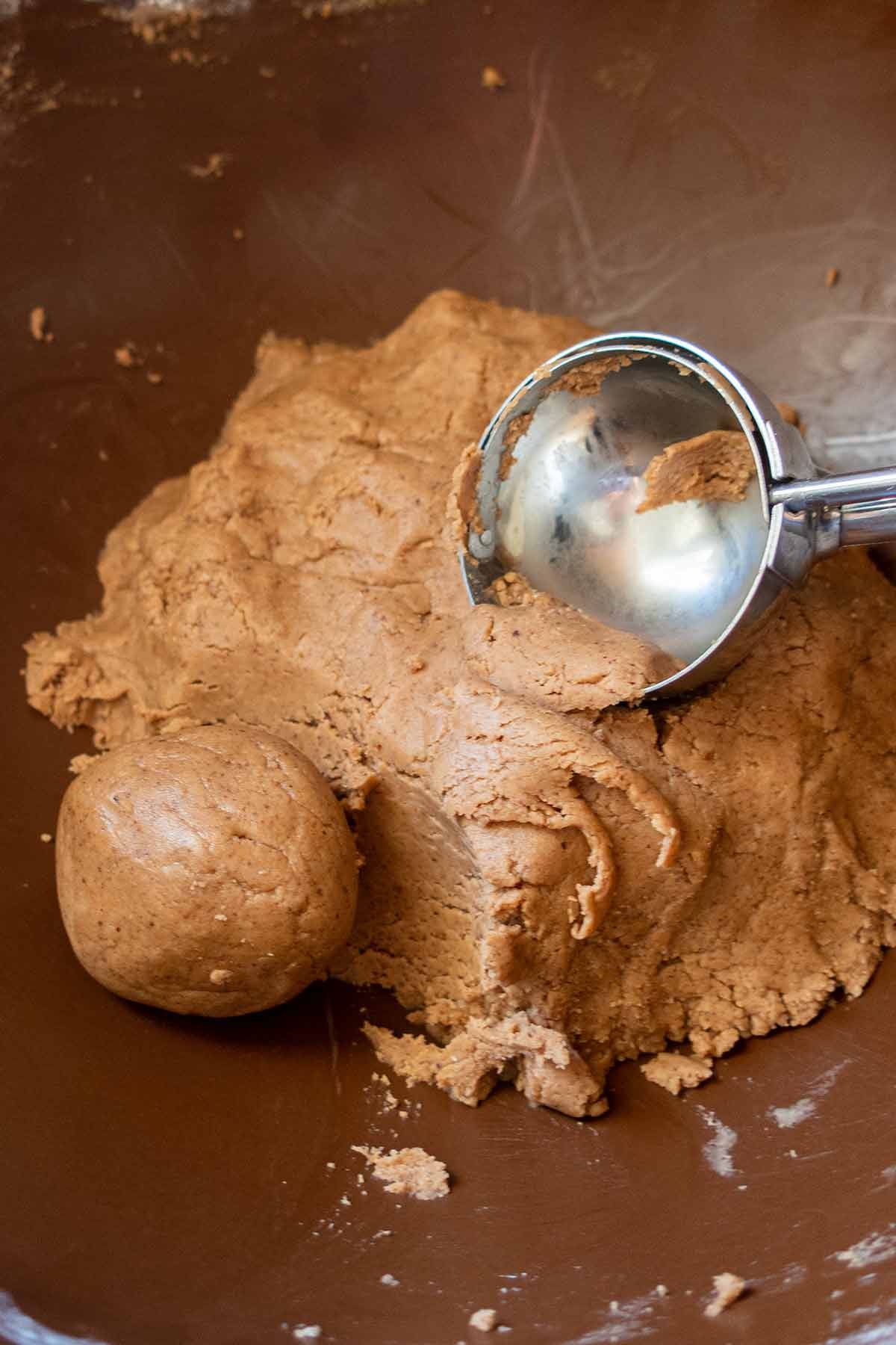 buckeye cookie dough in a bowl with cookie scoop