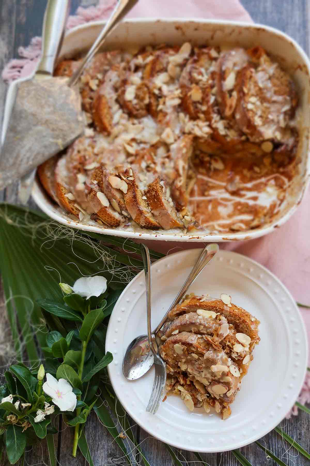 French toast casserole in a baking dish with a serving on a plate