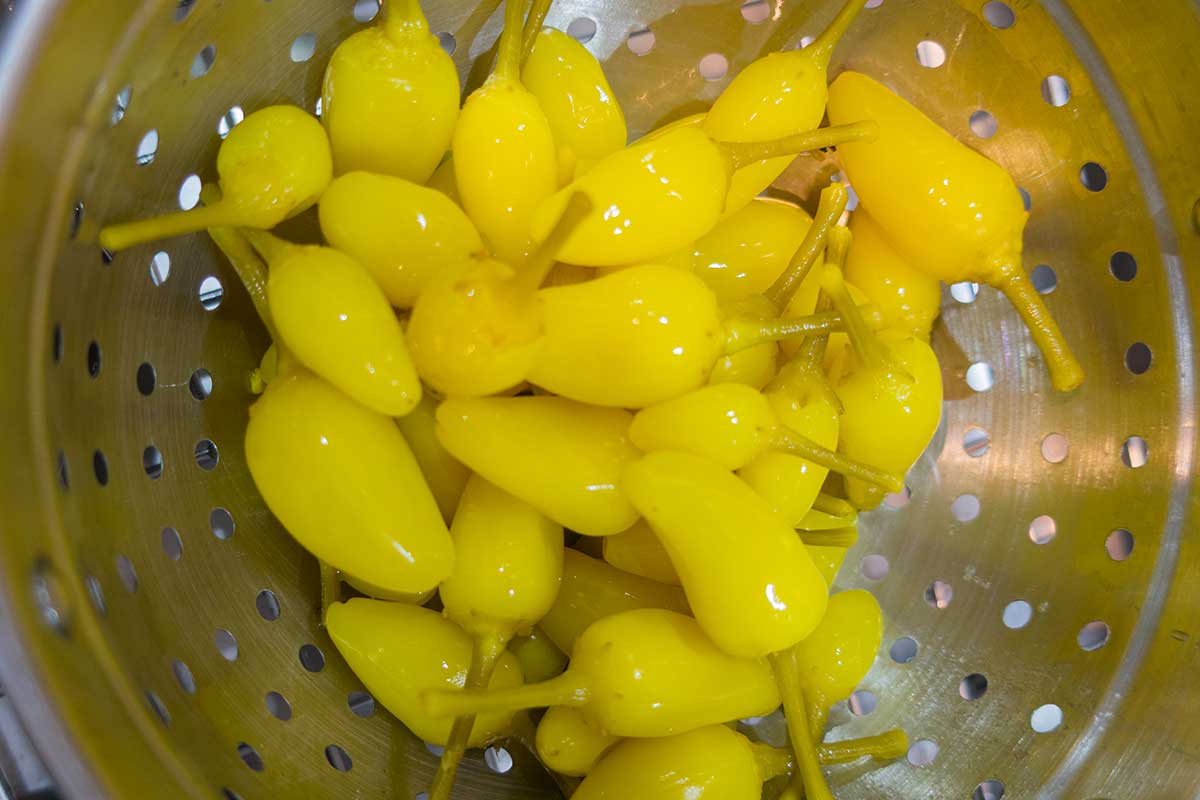 hot green chili peppers in a colander