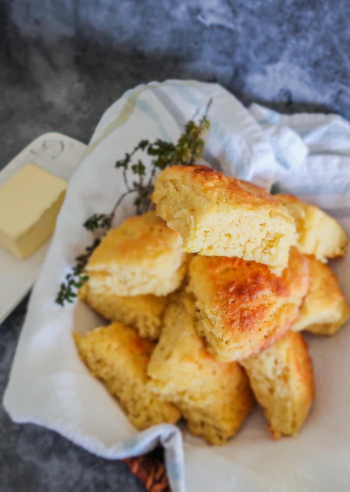 dinnner rolls in a basket with butter in a butter dish