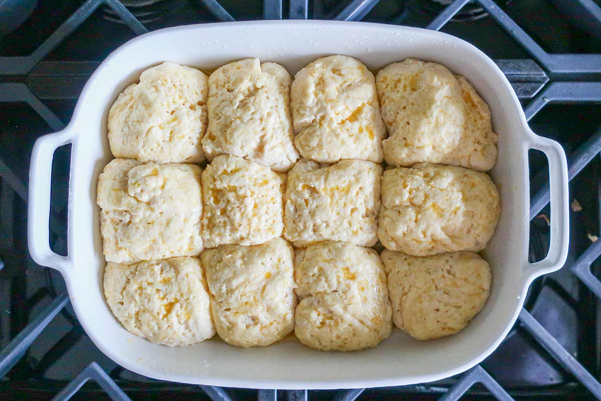 shaped rolls in a baking dish after rise