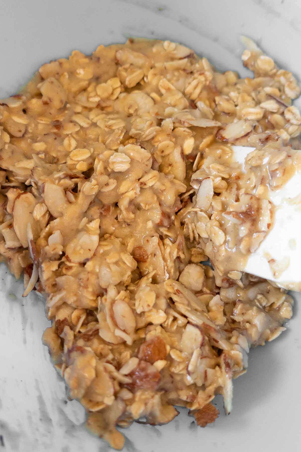 bar batter mixed with oats and sliced almonds in a bowl