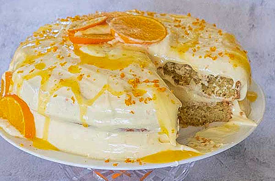 orange cake with icing on a plate