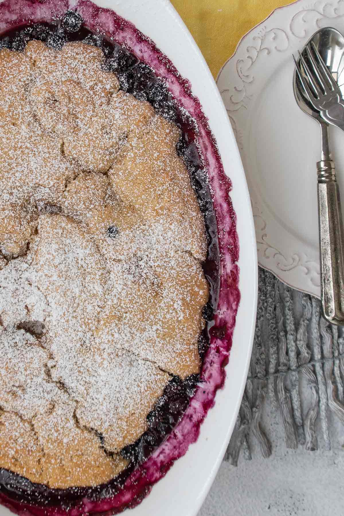 overview of baked blueberry pudding cake in a baking dish