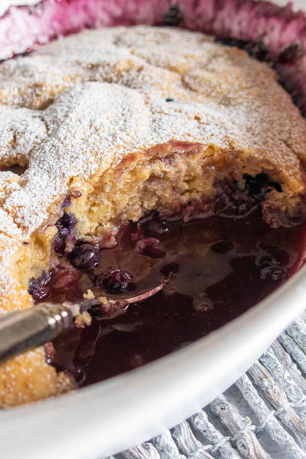 overview of pudding cake showcasing blueberries in a baking dish