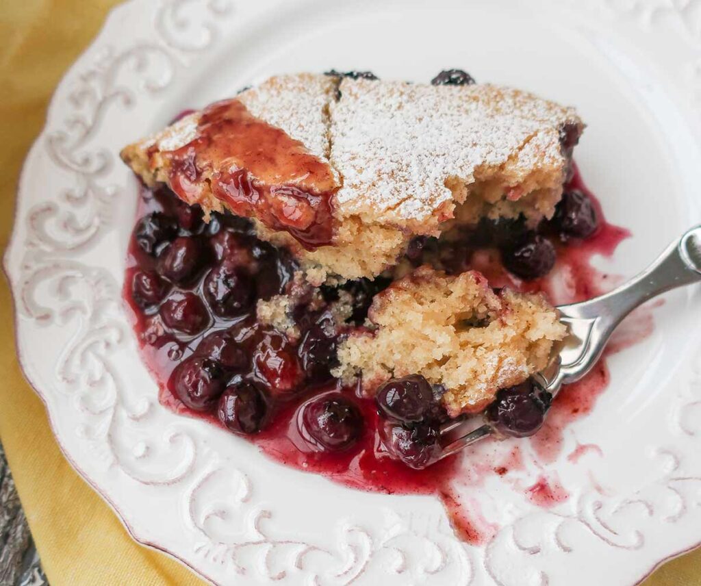 a slice of pudding cake with blueberries on a plate