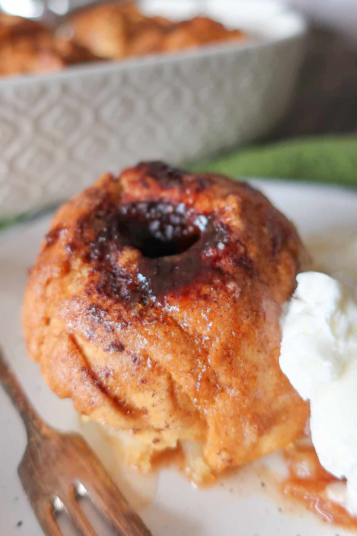 single old-fashioned apple dumpling on a plate with ice cream