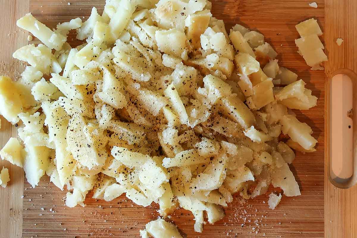 chopped baked potatoes on a cutting board