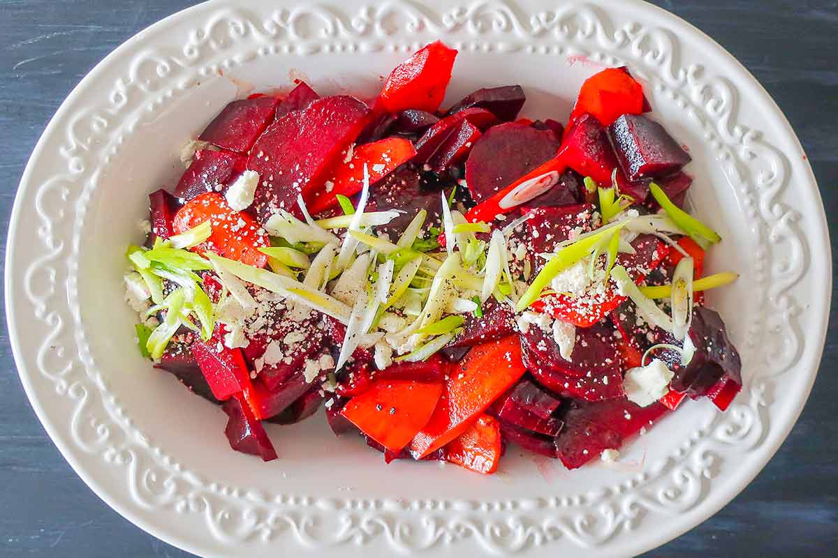 beet and carrot salad topped with feta in a salad bowl