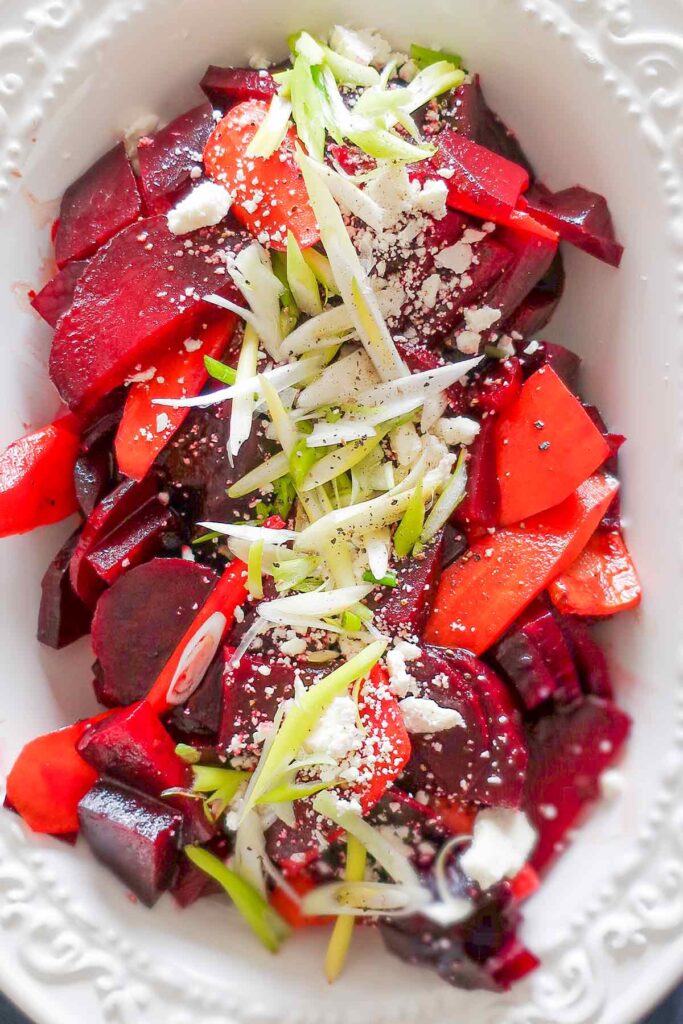 beet and carrot salad with feta cheese, green onions, balsamic vinegar on a salad platter