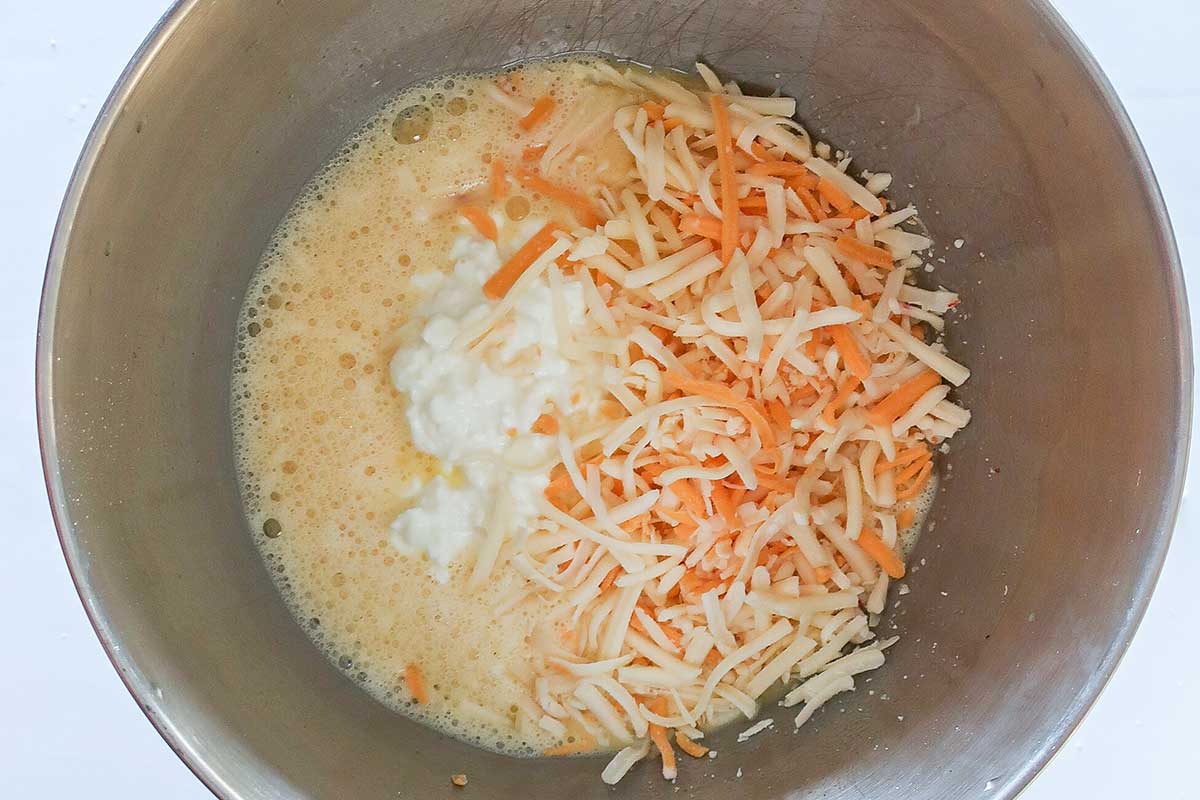 eggs mixed with cottage cheese, sour cream and shredded cheese in a bowl