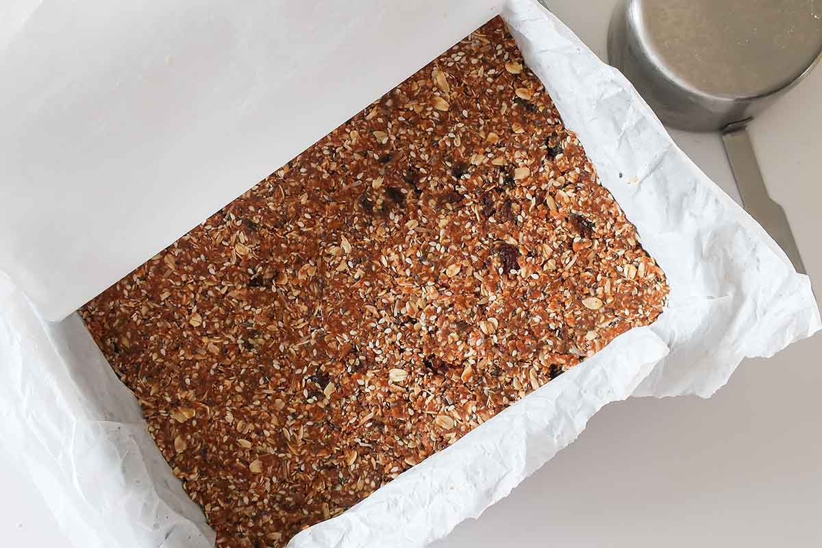 granola bar mixture firmly pressed in an 9x9 inch baking dish