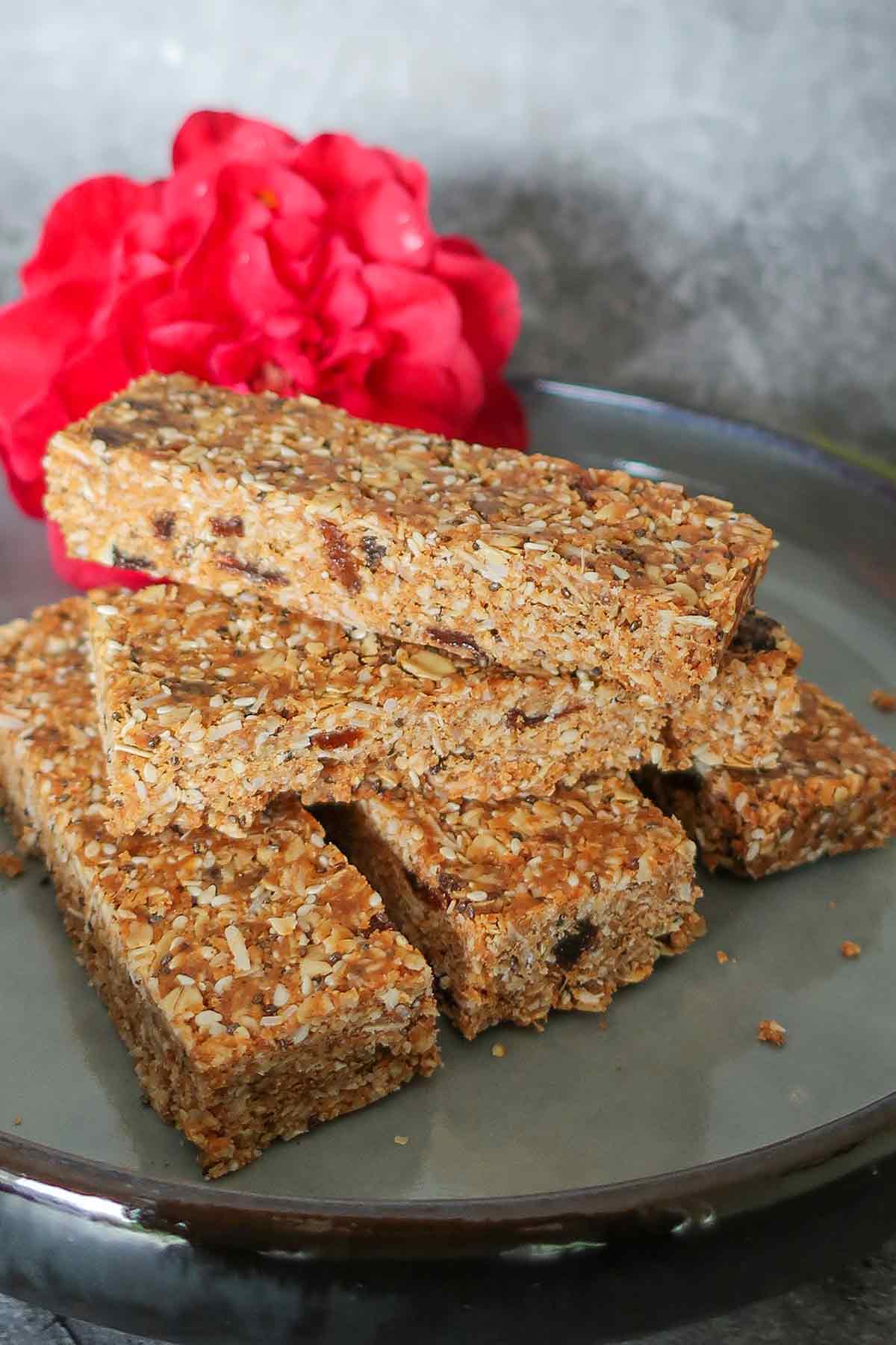 5 oat, fruit and nut bars stacked on a plate