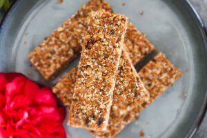 gluten free granola bars stacked on a plate with a rose